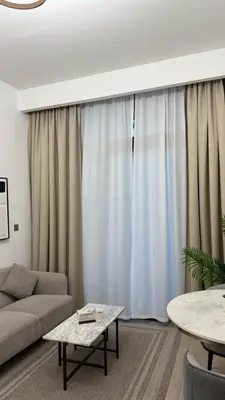 a living room with a couch and a table at VESTA - Dubai Residence in Dubai