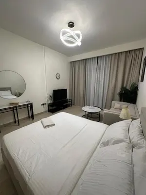 a bedroom with a large white bed and a living room at VESTA - Dubai Residence in Dubai