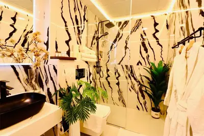 a bathroom with plants on the wall in a room at Barsana - Jumeirah Beach Villa - 2BDR - Marina Views in Dubai