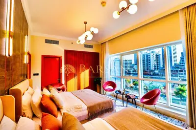a hotel room with a bed and a large window at Barsana - Jumeirah Beach Villa - 2BDR - Marina Views in Dubai