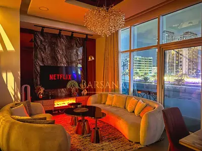 a living room with a couch and a tv at Barsana - Jumeirah Beach Villa - 2BDR - Marina Views in Dubai