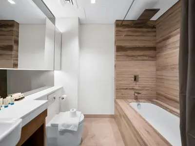 a bathroom with a tub and a toilet and a sink at Cozy modern STUDIO in STERLING DOWNTOWN I DUBAI MALL I Sleeps 4 in Dubai