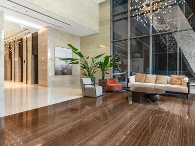 a lobby with a couch and a plant in a building at Cozy modern STUDIO in STERLING DOWNTOWN I DUBAI MALL I Sleeps 4 in Dubai