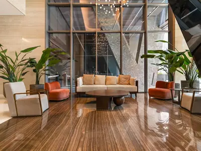 a lobby with a couch and a table and chairs at Cozy modern STUDIO in STERLING DOWNTOWN I DUBAI MALL I Sleeps 4 in Dubai