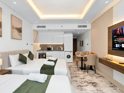 a hotel room with two beds and a dining room at Cozy modern STUDIO in STERLING DOWNTOWN I DUBAI MALL I Sleeps 4 in Dubai