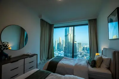 a bedroom with a large window with a city view at Luxury 3 BR Premium Feel Iconic Burj View Connected To Dubai Mall in Dubai