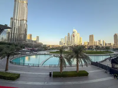 a large pool with palm trees in a city at Grande Signature Residences in Dubai