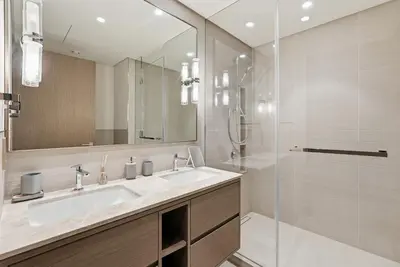 a bathroom with a sink and a shower at Grande Signature Residences in Dubai