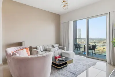 a living room with a couch and a table at Grande Signature Residences in Dubai