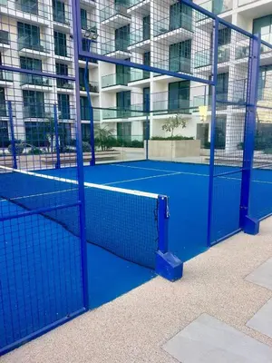 a tennis court in front of a building at Stylish Dubai Stay, Pool, Padel, Gym, Concierge in Dubai