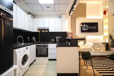 a kitchen with a washer and dryer at Elite LUX Holiday Homes - Cozy Studio at Al Waleed Garden 2, Dubai in Dubai