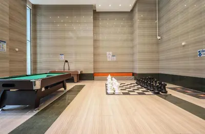 a room with a pool table and chessboards at Elite LUX Holiday Homes - Stylish 1BR Living in Amna Tower, Al Habtoor City in Dubai