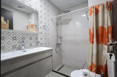 a bathroom with a shower and a sink and a toilet at Elite LUX Holiday Homes - Stylish Studio at Jewelz by Danube, Dubai in Dubai