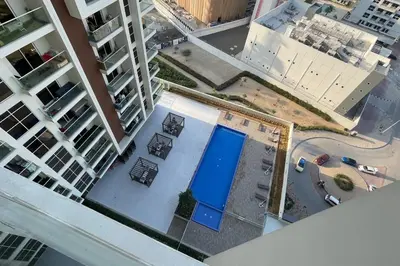 an overhead view of a pool in a city with buildings at Elite LUX Holiday Homes - Stylish Studio at Jewelz by Danube, Dubai in Dubai