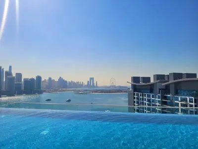 a swimming pool with a view of a city at Beach access, next to shopping mall in Dubai