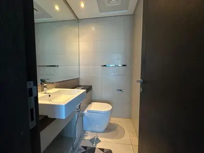 a bathroom with a white toilet and a sink at Next to Marina Mall, Close to beach and Metro in Dubai