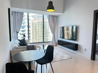 a living room with a couch and a table at Next to Marina Mall, Close to beach and Metro in Dubai