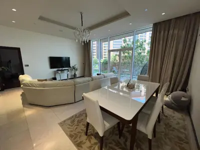 a living room with a table and a couch at Private beach, Close to Shopping Mall in Dubai