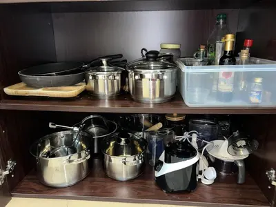 a bunch of pots and pans sitting on a shelf at Private beach, Close to Shopping Mall in Dubai