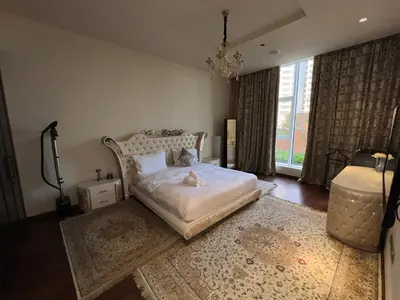 a bedroom with a bed with a cat laying on it at Private beach, Close to Shopping Mall in Dubai