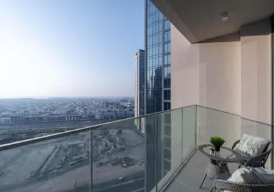 a balcony with a table and a view of a city at Forte Luxury 2BR Apartment with Skyline City Views near Dubai Mall in Dubai