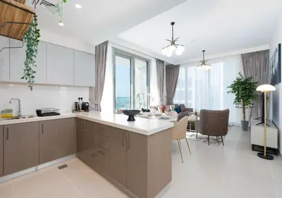 a kitchen and living room with a view of the ocean at Forte Luxury 2BR Apartment with Skyline City Views near Dubai Mall in Dubai