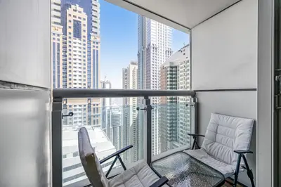 a balcony with two chairs and a view of the city at Ample space 2BR Princess towers Marina in Dubai