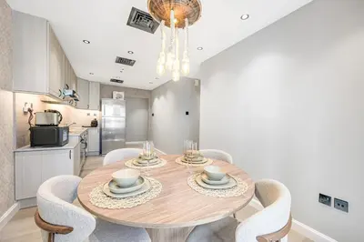 a dining room with a wooden table and chairs at Ample space 2BR Princess towers Marina in Dubai