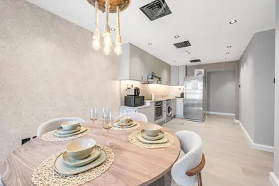 a dining room with a wooden table and chairs at Ample space 2BR Princess towers Marina in Dubai