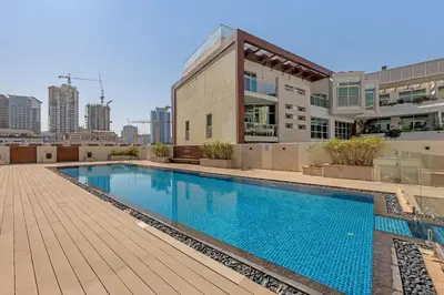 a swimming pool on the roof of a building at Waves - Modern Studio Retreat W Pool & Gym Access in Dubai