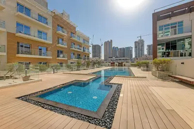 a swimming pool in the middle of a building at Waves - Modern Studio Retreat W Pool & Gym Access in Dubai