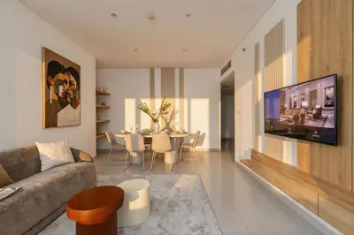 a living room with a couch and a table at 3 Bedroom Hotel Apartment with Gym, Spa and Pool in Dubai