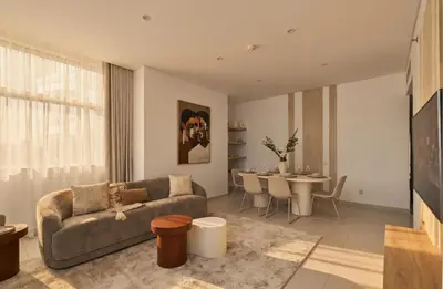 a living room with a couch and a table at 3 Bedroom Hotel Apartment with Gym, Spa and Pool in Dubai