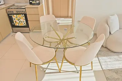 a glass table and chairs in a kitchen at CH Skyline Bliss 1 BR near Burj Khalifa in Dubai