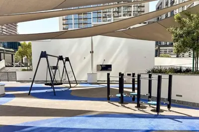 a playground with a swing set in a building at Brand New 1 Bedroom Apartment in Sobha Hartland Dubai in Dubai