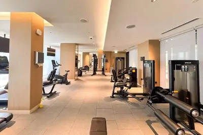 a gym with treadmills and exercise equipment in a building at Brand New 1 Bedroom Apartment in Sobha Hartland Dubai in Dubai