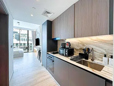 a kitchen with a sink and a counter top at Stylish Contemporary Studio in Oxford Gardens in Dubai
