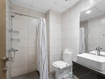 a bathroom with a toilet and a sink at The Cozy Corner Studio In Chaimaa in Dubai