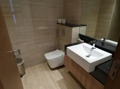 a bathroom with a sink and a toilet and a mirror at Urban Oasis by Missoni in Dubai
