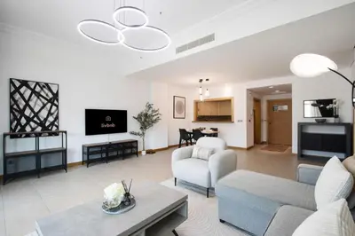 a living room with a couch and a table at Spacious 1B in Palm Close to Palm Mall in Dubai