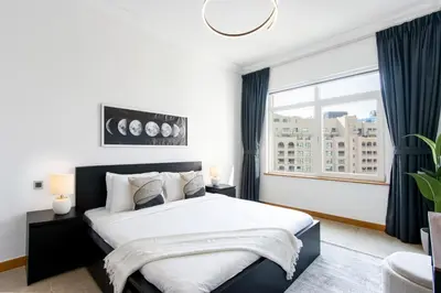 a bedroom with a large bed and a window at Spacious 1B in Palm Close to Palm Mall in Dubai