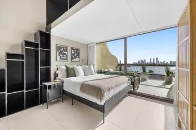 a bedroom with a bed and a large window at LUX Seaview Studio - Beach Access in Dubai