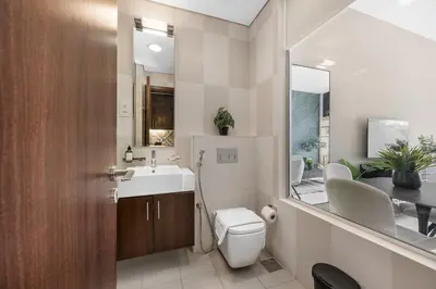 a bathroom with a toilet and a sink and a mirror at LUX Seaview Studio - Beach Access in Dubai