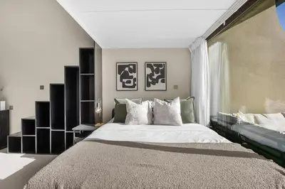 a bedroom with a large bed and a large window at LUX Seaview Studio - Beach Access in Dubai