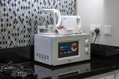 a microwave sitting on top of a kitchen counter at Dubai Business Bay Modern Cozy Studio with Skyline Views & Lagoon Pool Access in Dubai