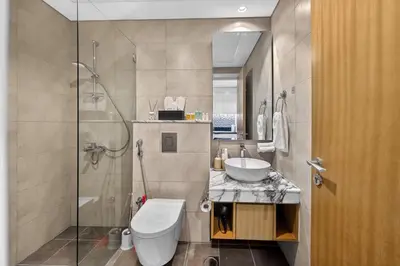 a bathroom with a shower and a toilet and a sink at Dubai Business Bay Modern Cozy Studio with Skyline Views & Lagoon Pool Access in Dubai