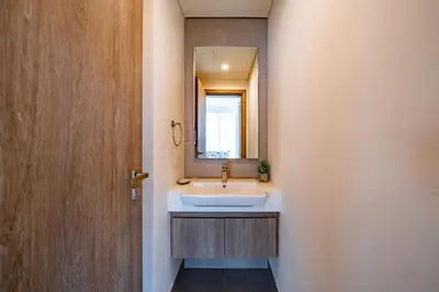 a bathroom with a sink and a mirror at Homes Beyond l Marina Luxe 1BR at LIV in Dubai