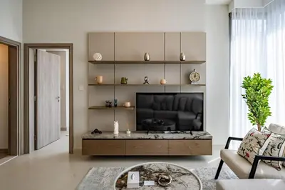a living room with a couch and a television at Homes Beyond l Marina Luxe 1BR at LIV in Dubai