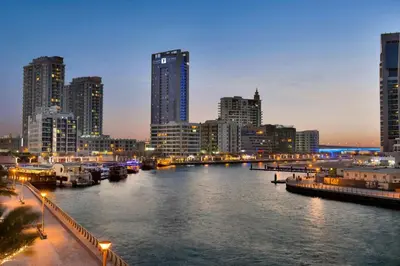 a view of a city with a river at night at The First Collection Marina, Dubai, a Tribute Portfolio Hotel in Dubai