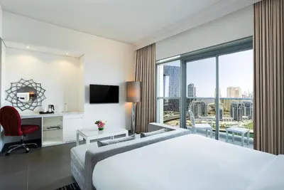a hotel room with a bed and a large window at The First Collection Marina, Dubai, a Tribute Portfolio Hotel in Dubai
